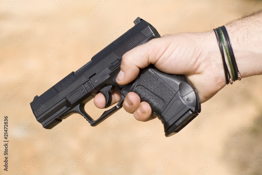 Person holding black handgun