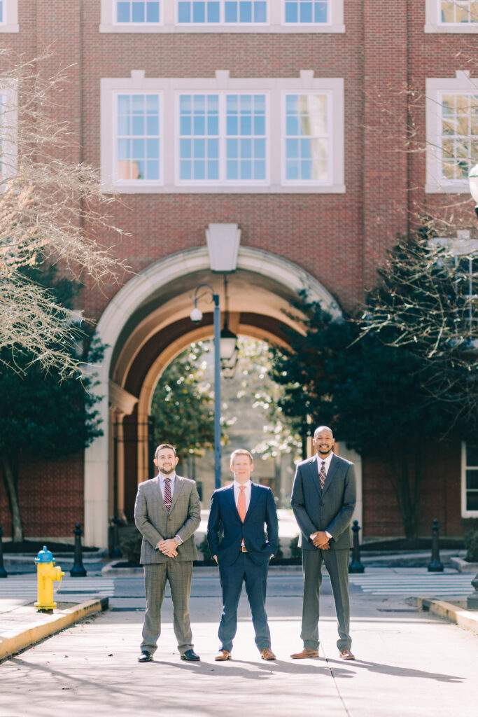 Attorney John Barnes, Attorney Brandon D. Fersten, and Attorney Oscar Butler standing outside