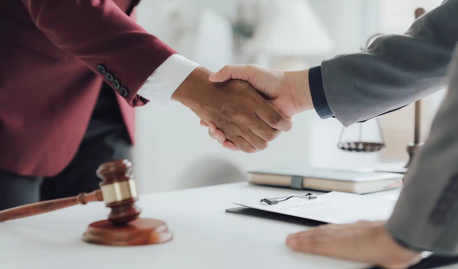 Attorney shaking client's hand