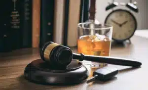Judge's gavel next to whiskey