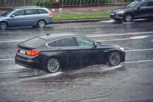 Car driving through heavy rain
