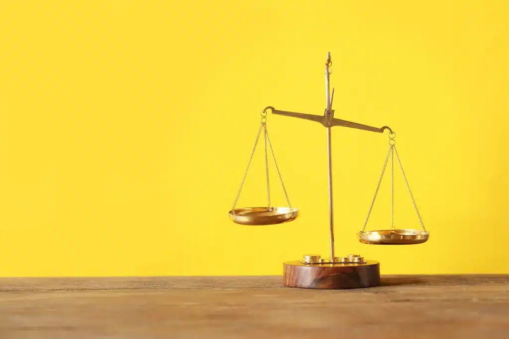 Scales of justice w/ yellow background