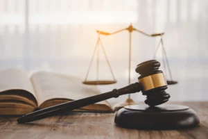 Gavel next to scales of justice and legal books