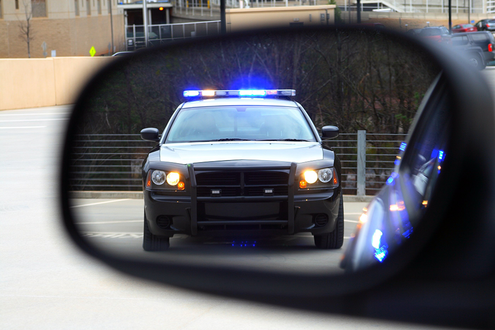 Police cruiser in vehicle side mirror