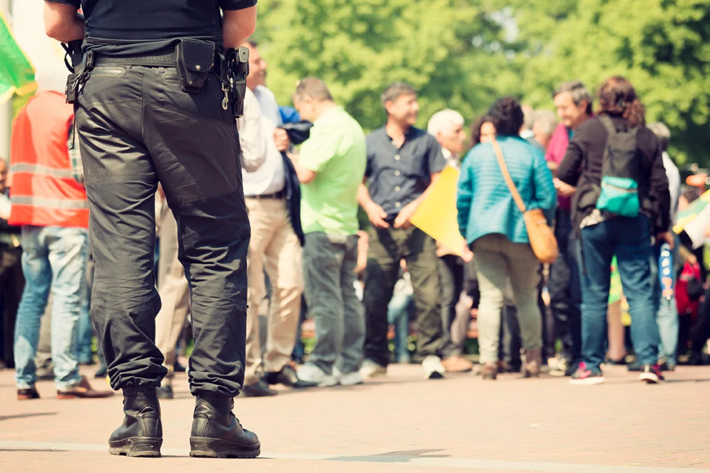 Police officer observing a crowd